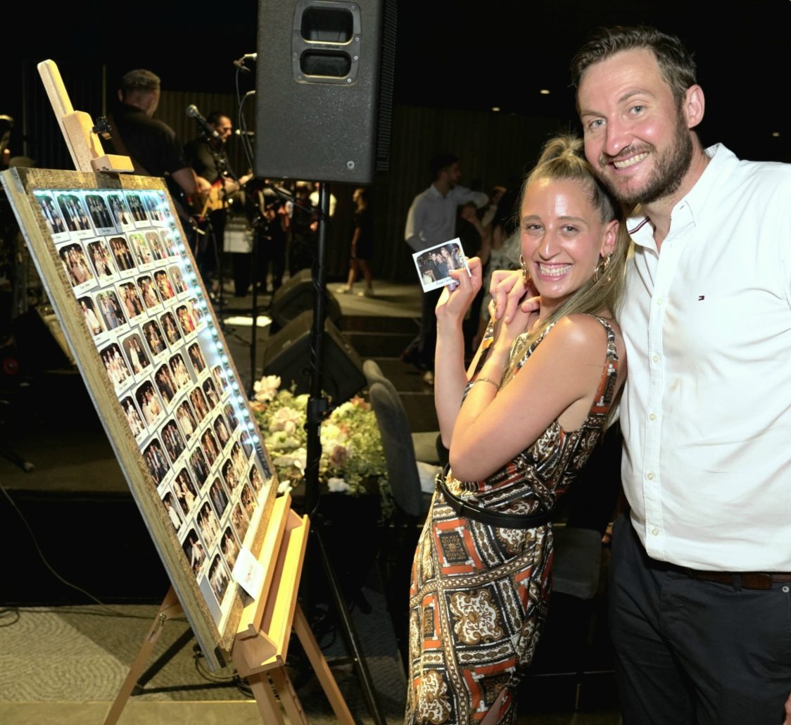 A couple holding their photo magnet together
