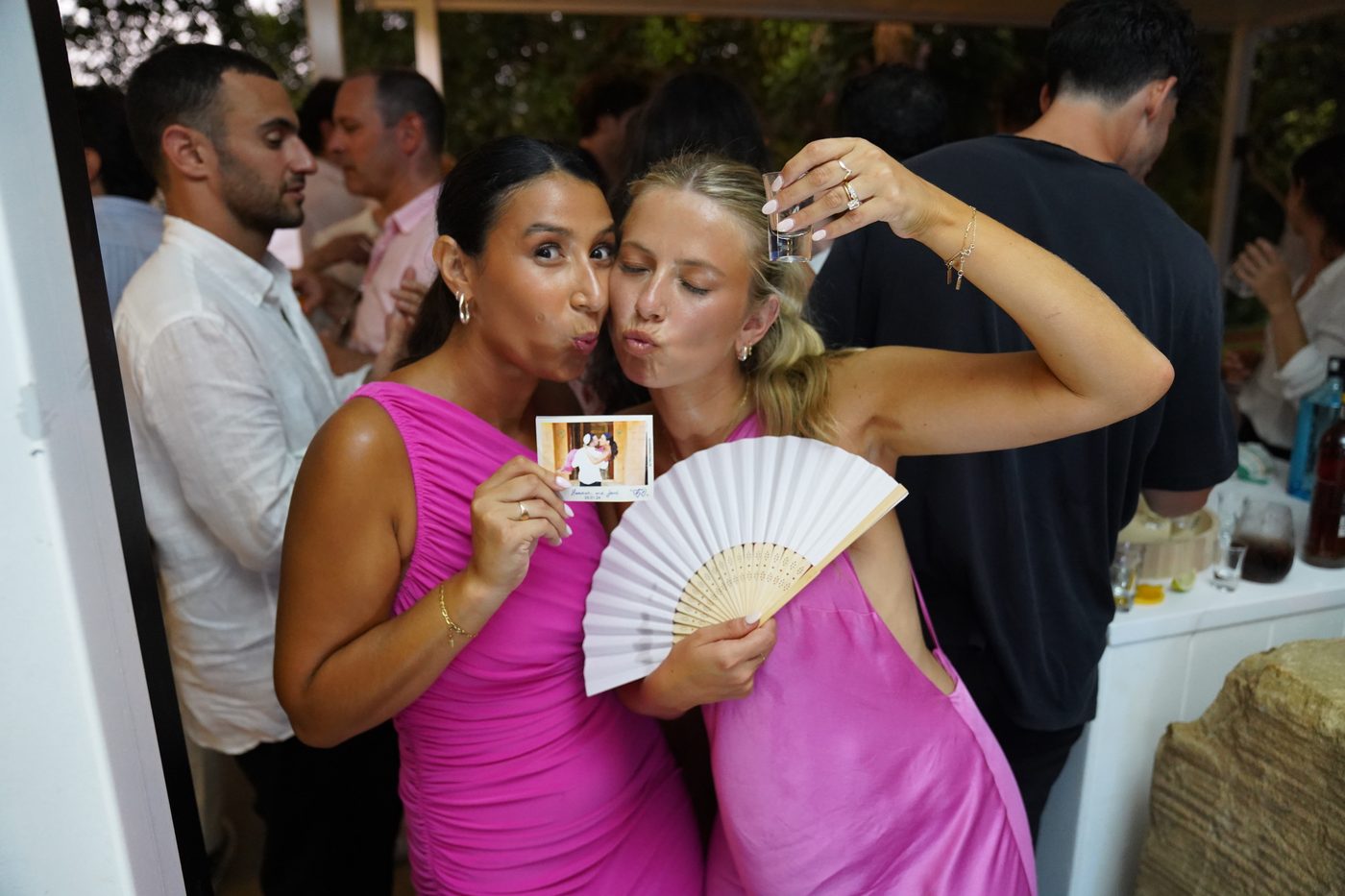 A guest holding a photo magnet during a celebration