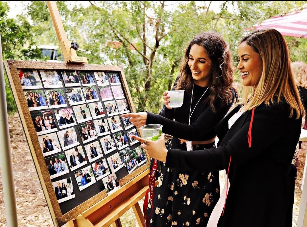 Guests with their photo magnets at an outdoor event